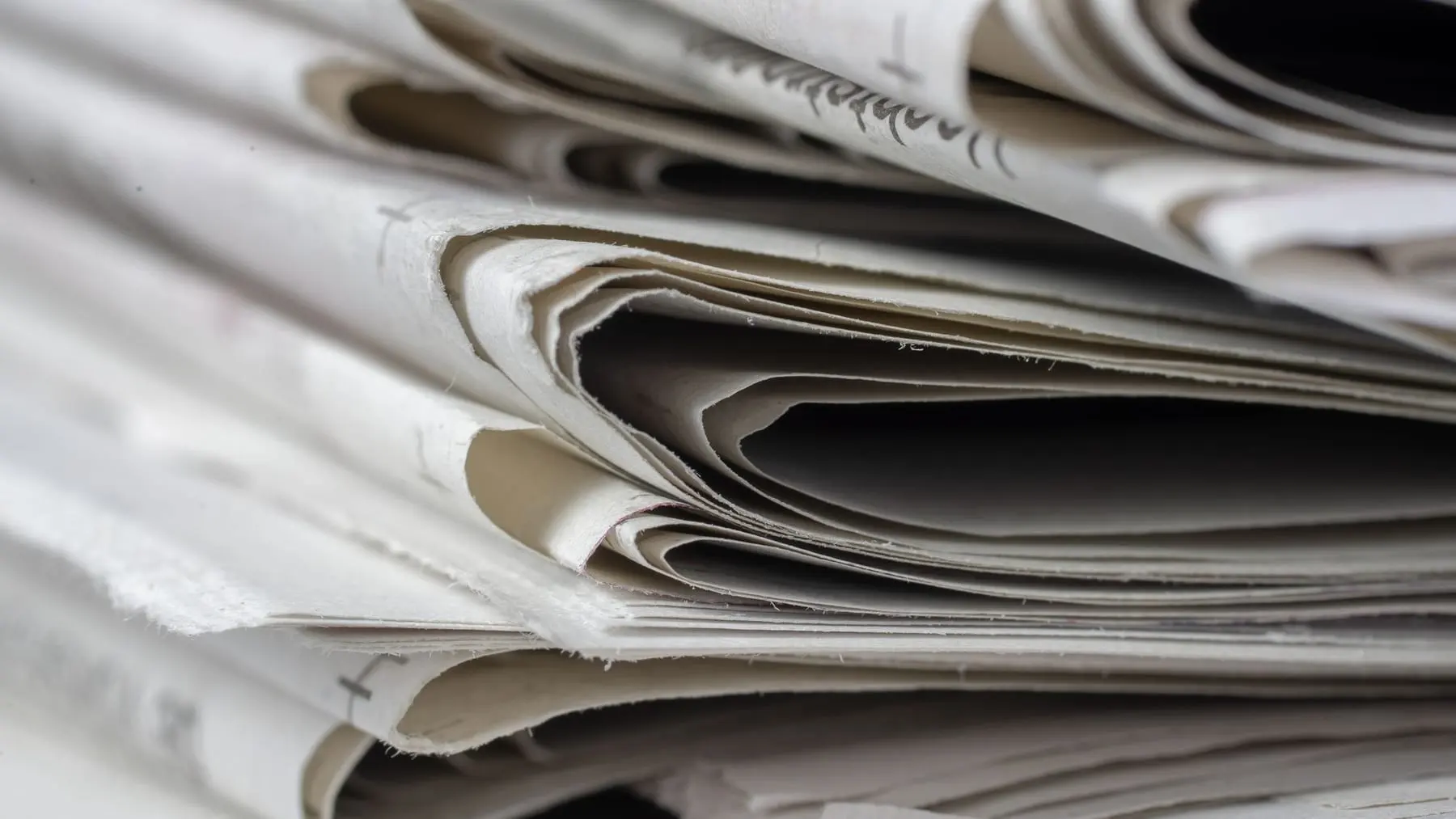 A stack of folded newspapers
